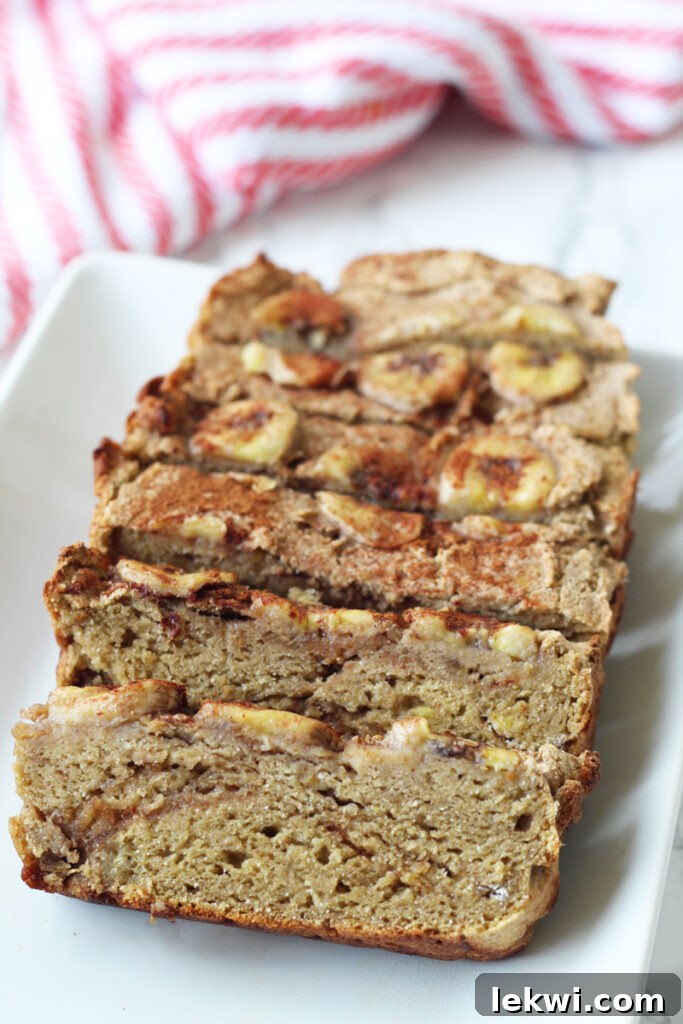 A beautifully baked loaf of AIP banana bread on a platter, ready to be served.