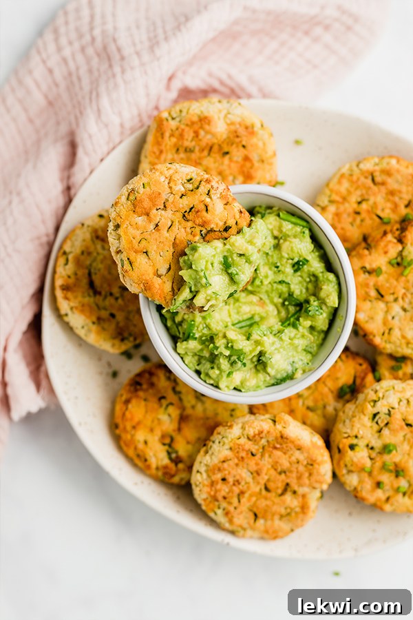 baked veggie nuggets on plate with guacamole and a bite out of one nugget