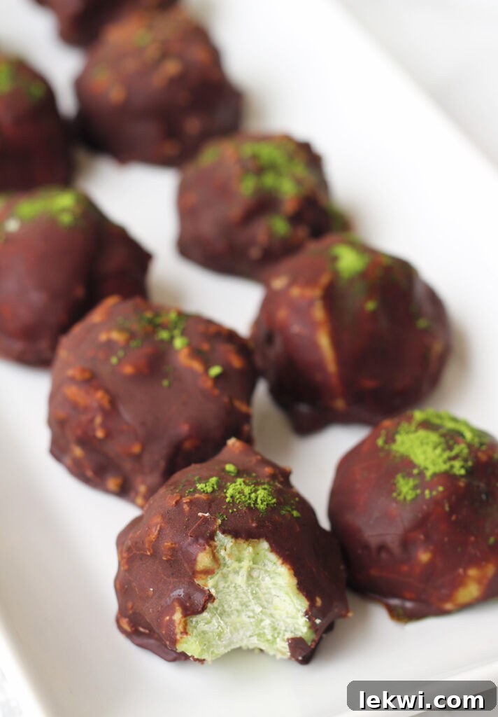 A row of chocolate matcha energy balls sitting on a platter.
