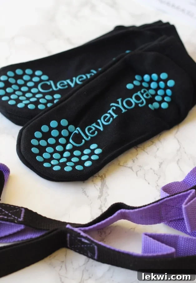 A set of yoga socks and a yoga strap sitting on a serene background, ready for a practice session.