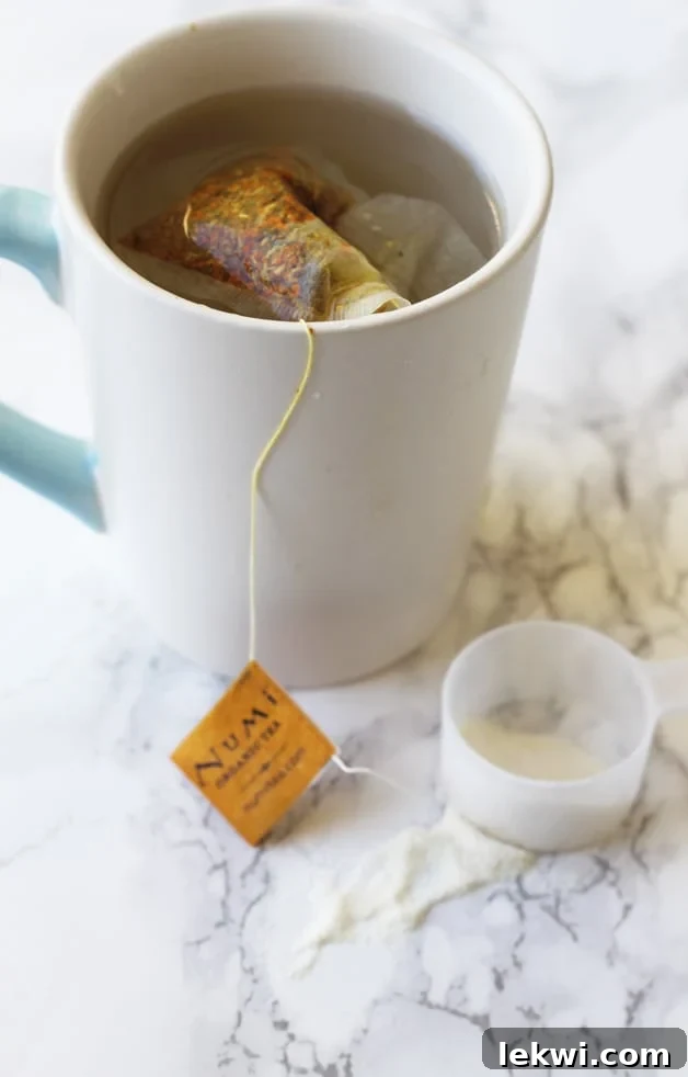 A warm mug of Numi Organic Turmeric Tea with a serving of Vital Proteins Collagen next to it, symbolizing a nourishing ritual.