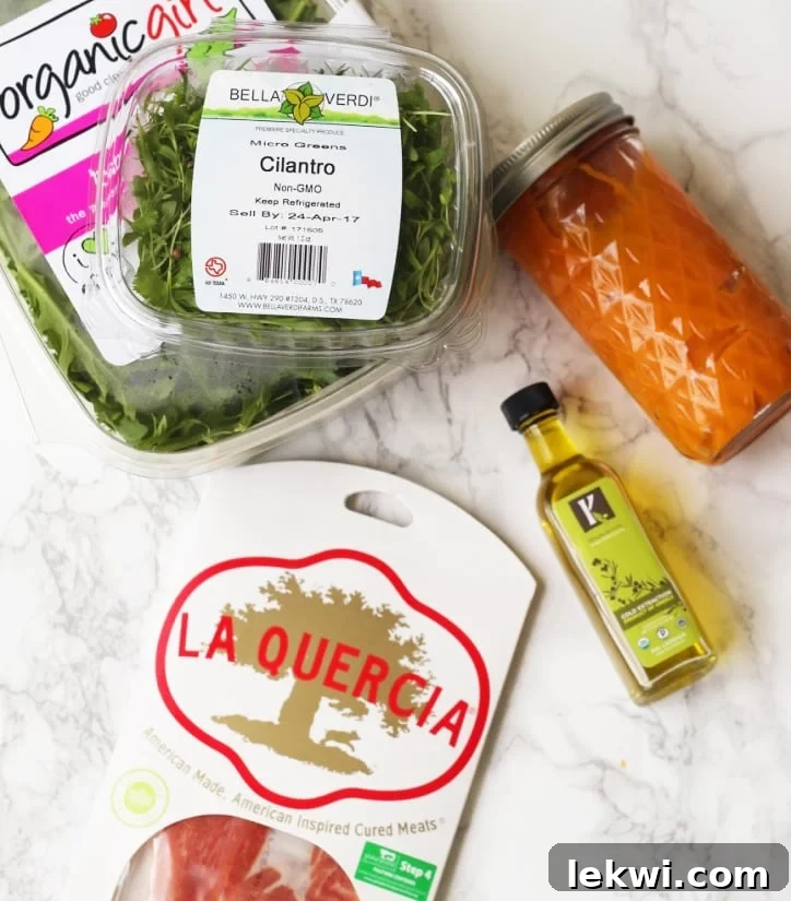 A selection of fresh ingredients including greens, cilantro, cured meats, and olive oil, arranged neatly before being prepared into a healthy meal.
