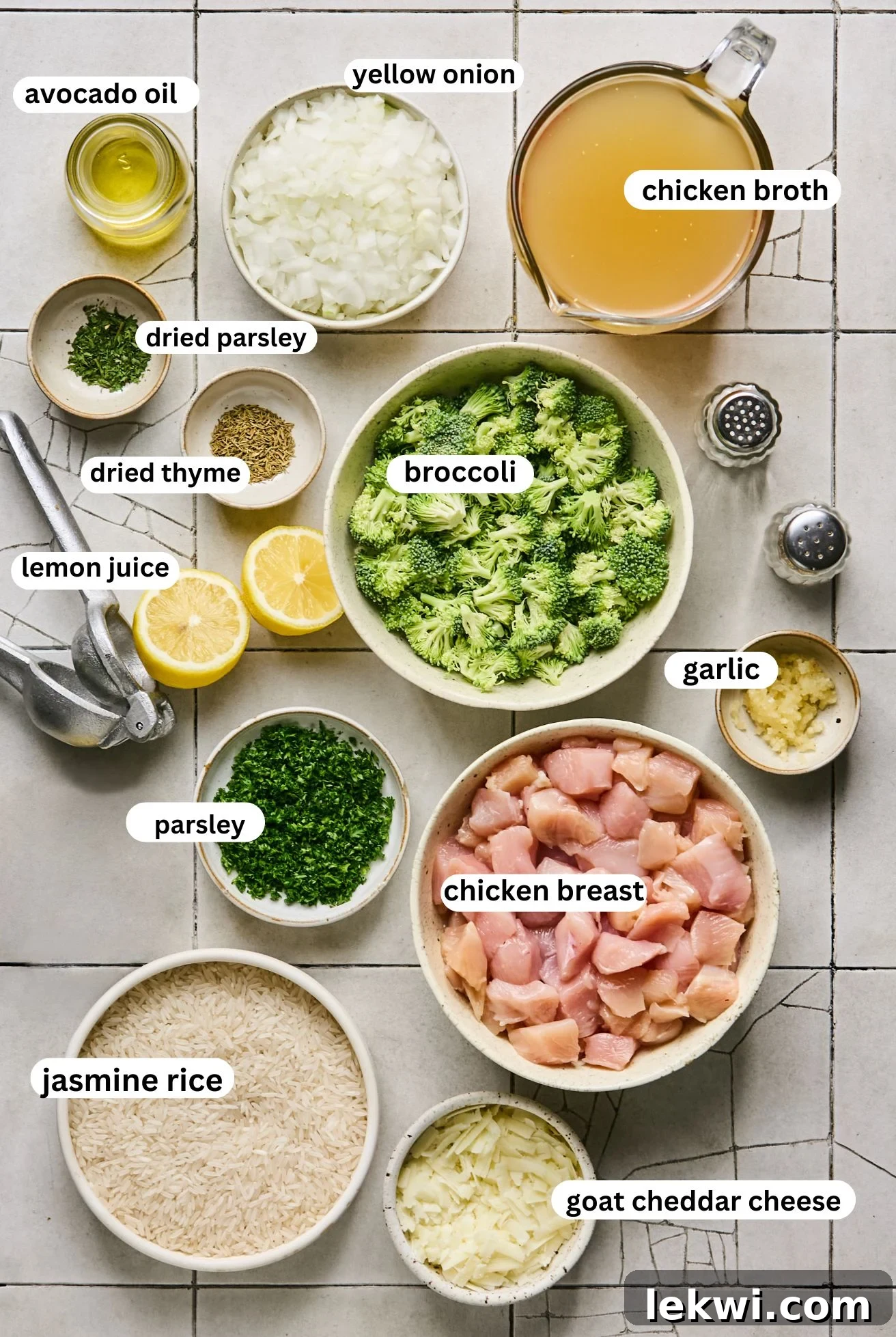 Separated ingredients for One-Pot Broccoli Cheddar Chicken and Rice, arranged in bowls on a white background.