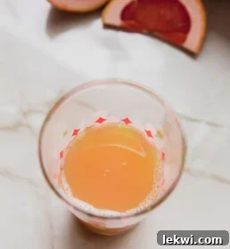 Paloma mocktail ingredients are combined in a cocktail shaker, ready for mixing.