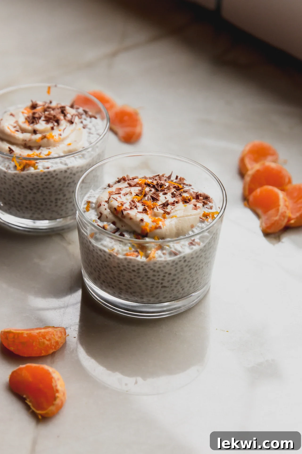 Cannoli chia pudding in a small glass jar topped off with chocolate shavings and orange zest.