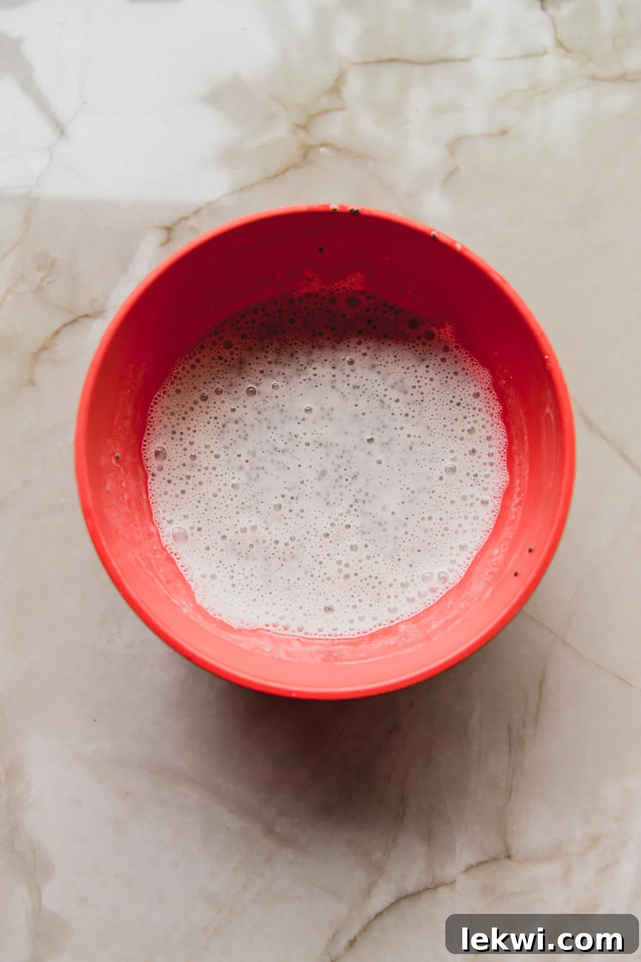 The chia seed mixture after being thoroughly whisked, showing a smooth, homogenous liquid.
