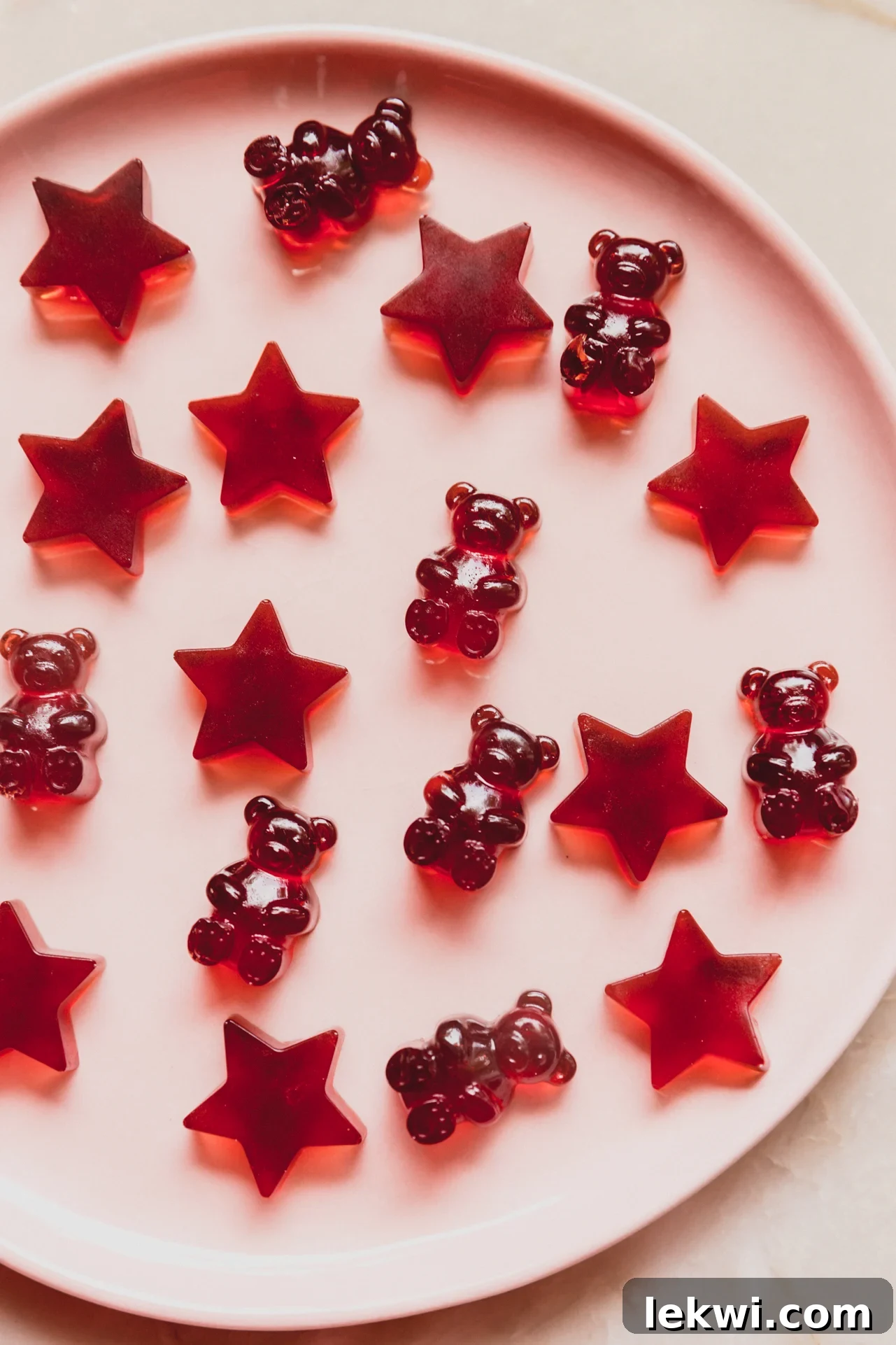 Vibrant tart cherry gummies on a pink plate, ready for a restful night.