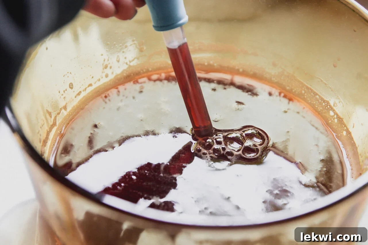 Dropper removing cherry gummy liquid.