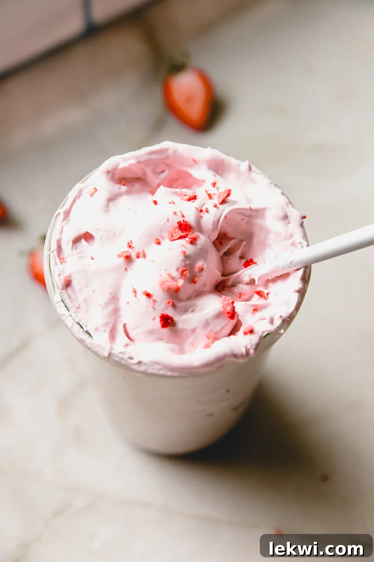 Strawberry marshmallow fluff in a glass jar topped off with crushed freeze dried strawberries.
