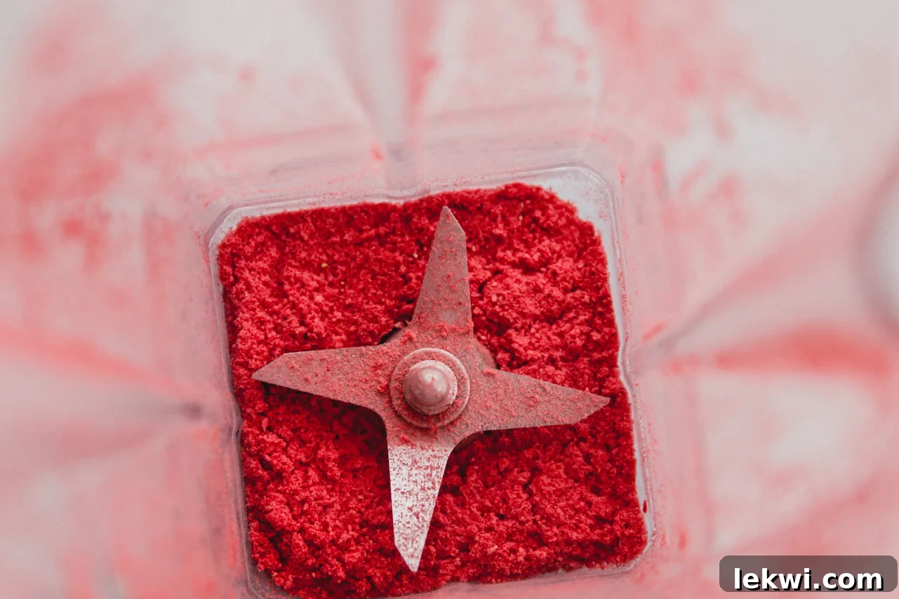 A blender full of freeze dried strawberries.