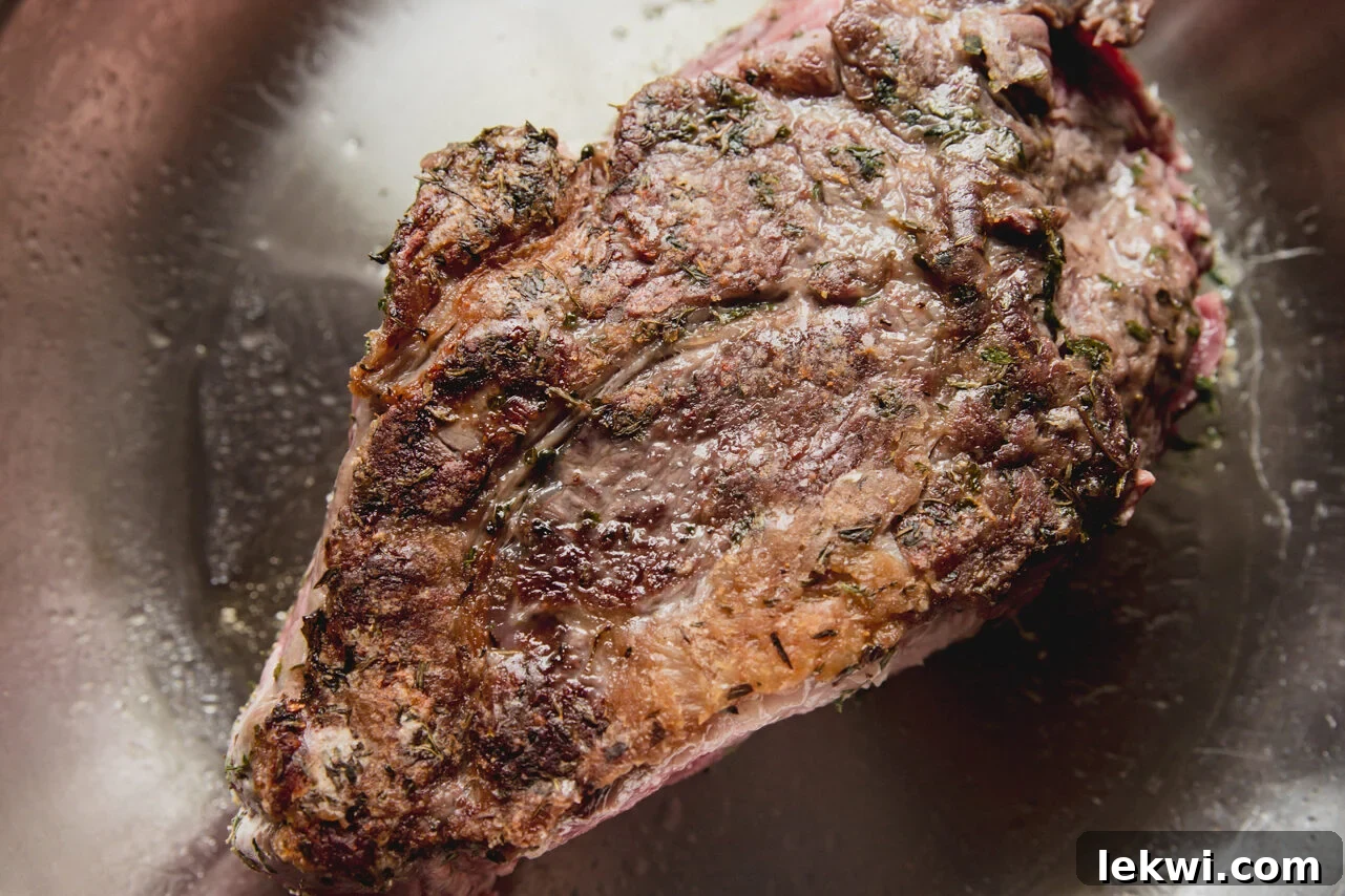 The chuck roast after being perfectly seared to a golden brown.