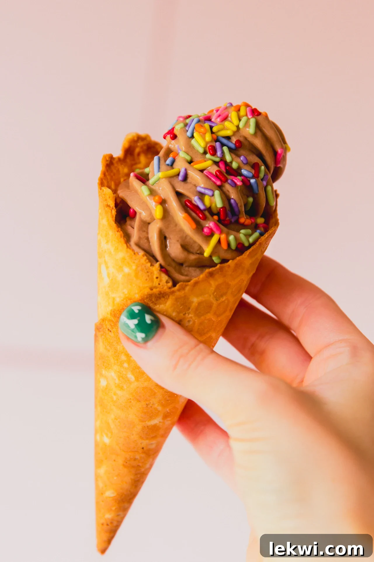 Chocolate protein ice cream in a cone, showcasing its creamy texture.