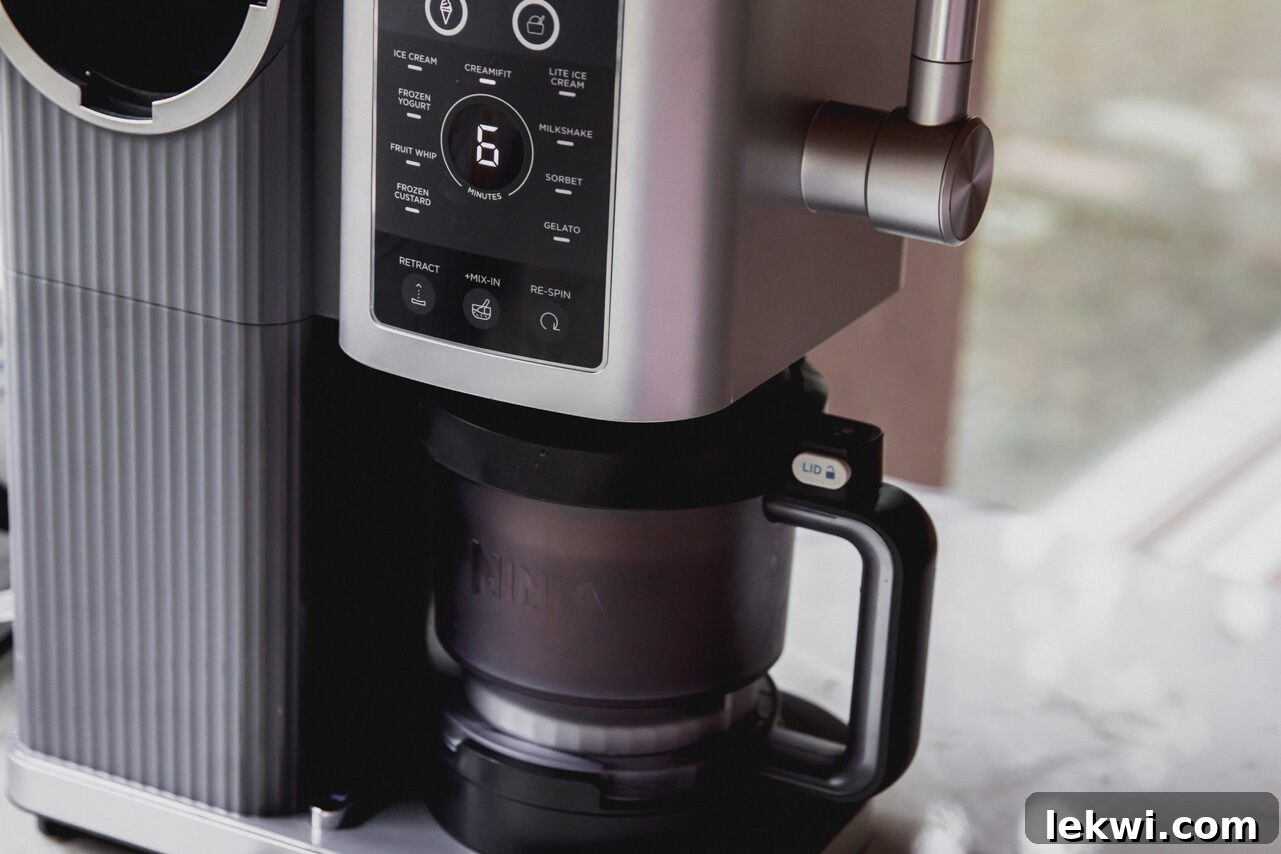 Ninja Creami machine during the spinning process of chocolate protein ice cream.