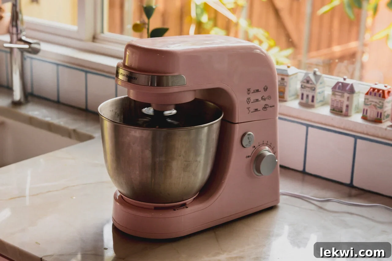 A stand mixer whipping the marshmallow fluff.