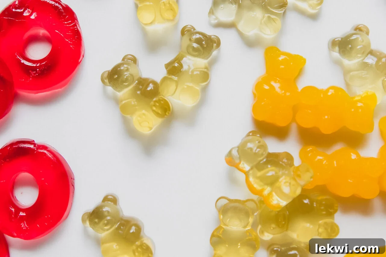 Assorted gummy rings and gummy bears arranged on a plate, ready for cake decoration.