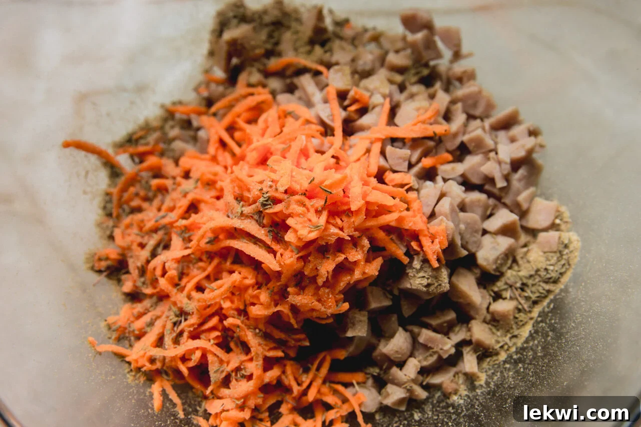 The sausage and shredded sweet potato in a bowl before mixing.