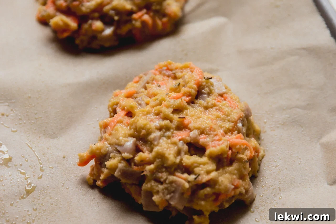 The dough for protein breakfast biscuits scooped out on a baking sheet.