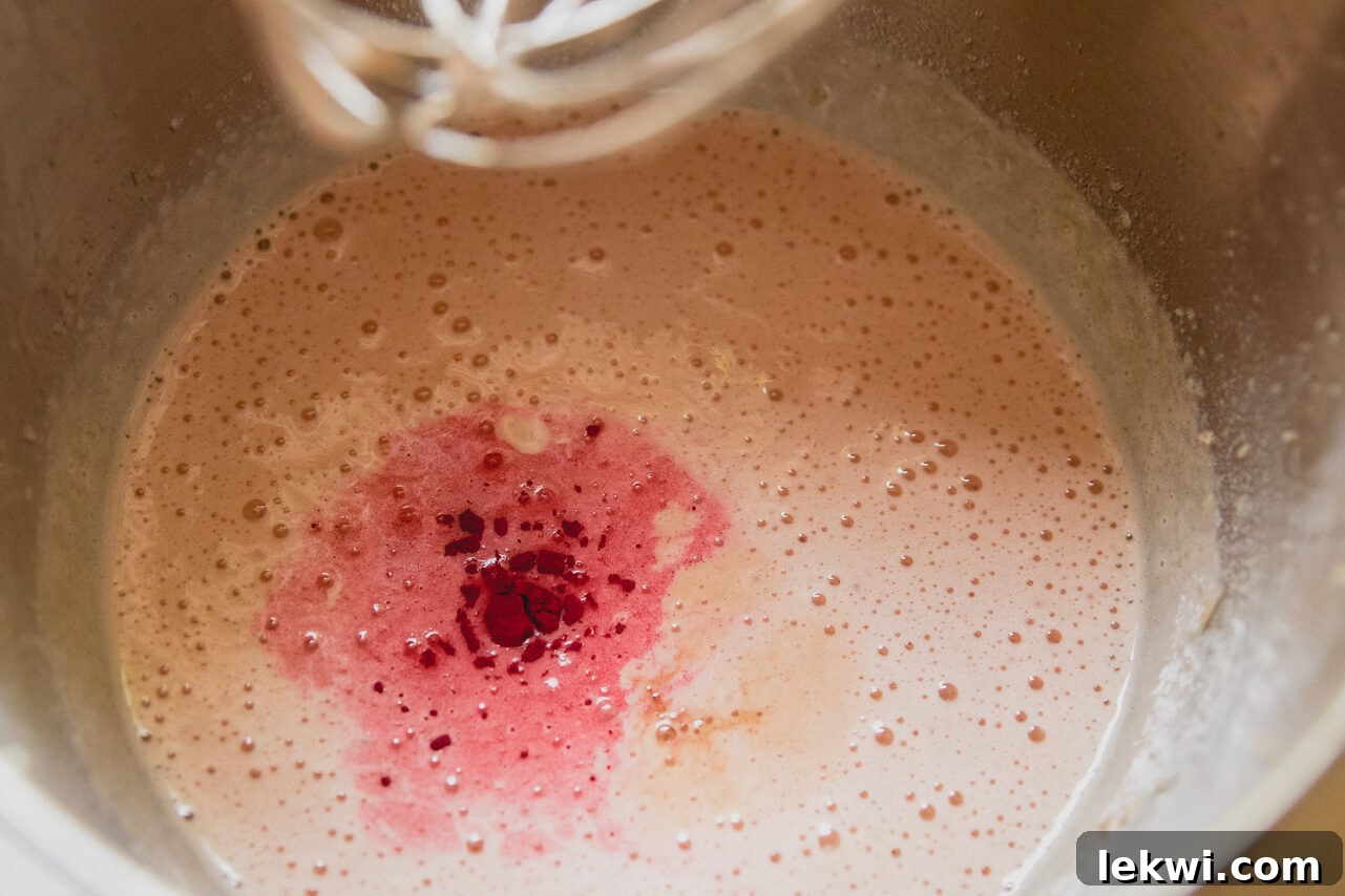 The pink layer being mixed in the stand mixer.