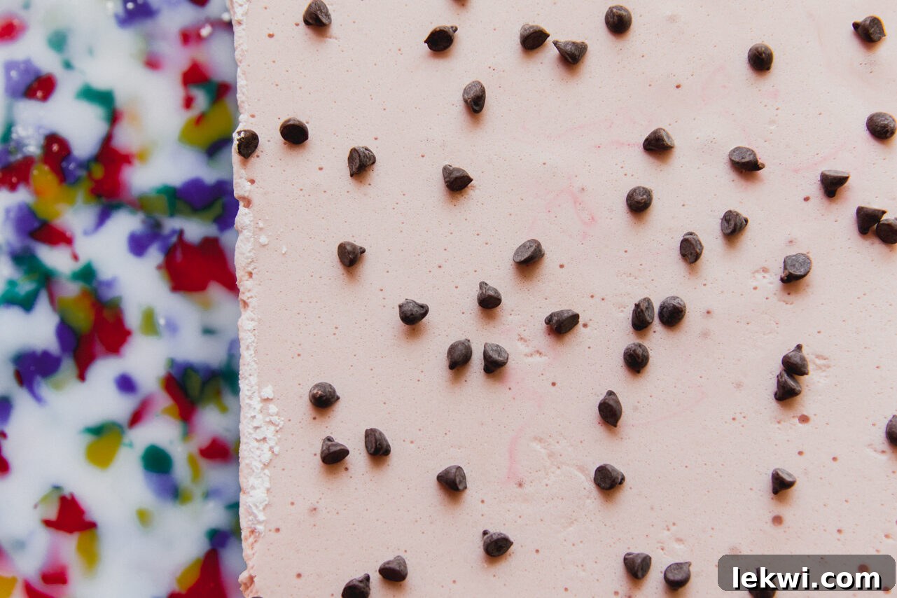 The marshmallows topped with chocolate chips before being sliced.