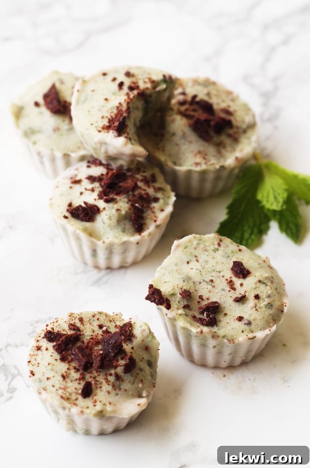 A stack of refreshing mint ice cream cups, perfectly portioned and ready to be enjoyed on a hot day.