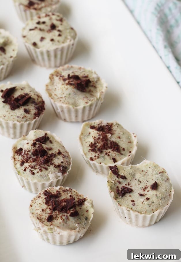 A close-up image of a single Mint Chip Banana Ice Cream Cup, highlighting its delightful texture, natural green color, and cocoa nib garnish.