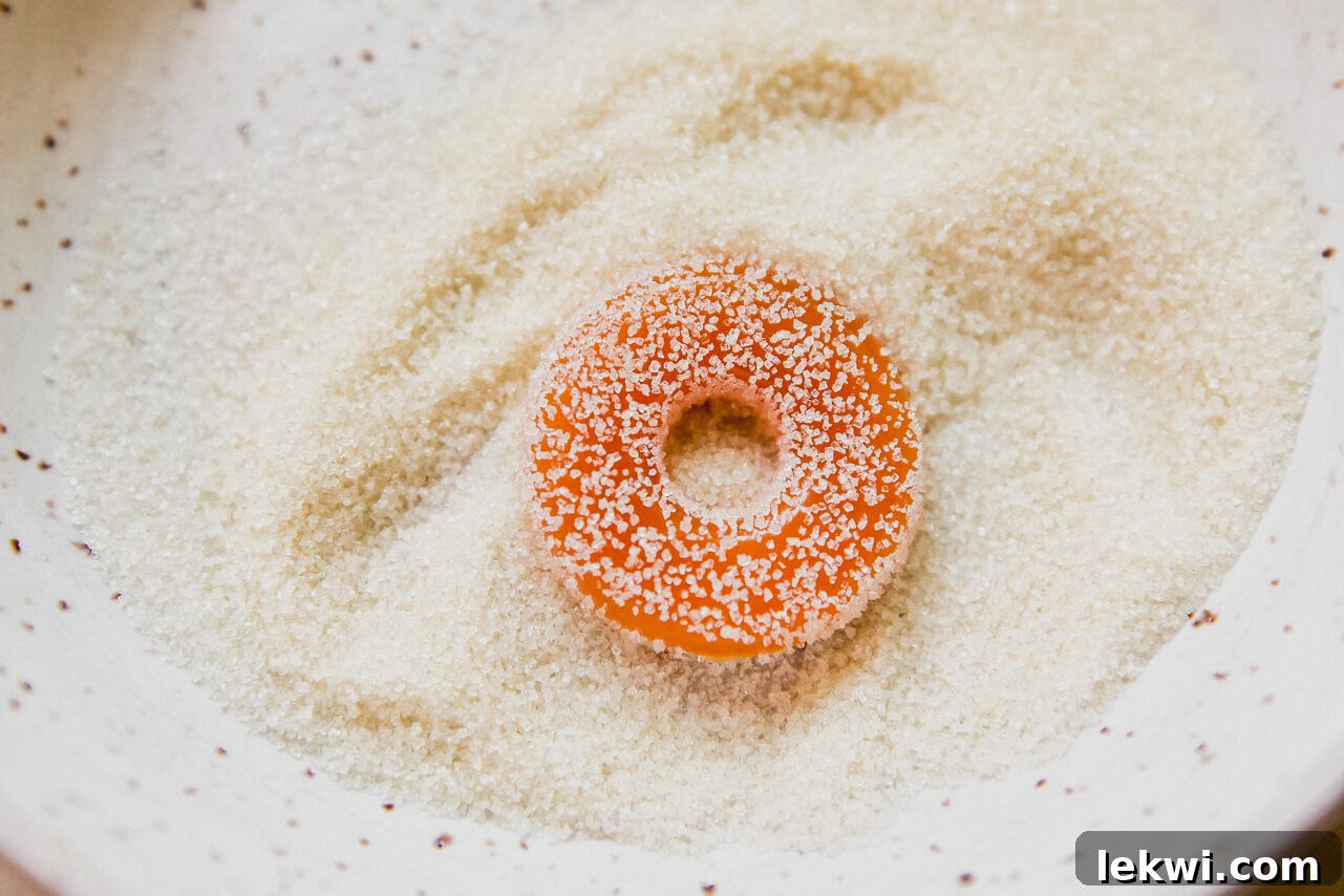 Protein peach rings are lightly coated in granulated sweetener, enhancing their classic appearance and adding a final touch of sweet sparkle.