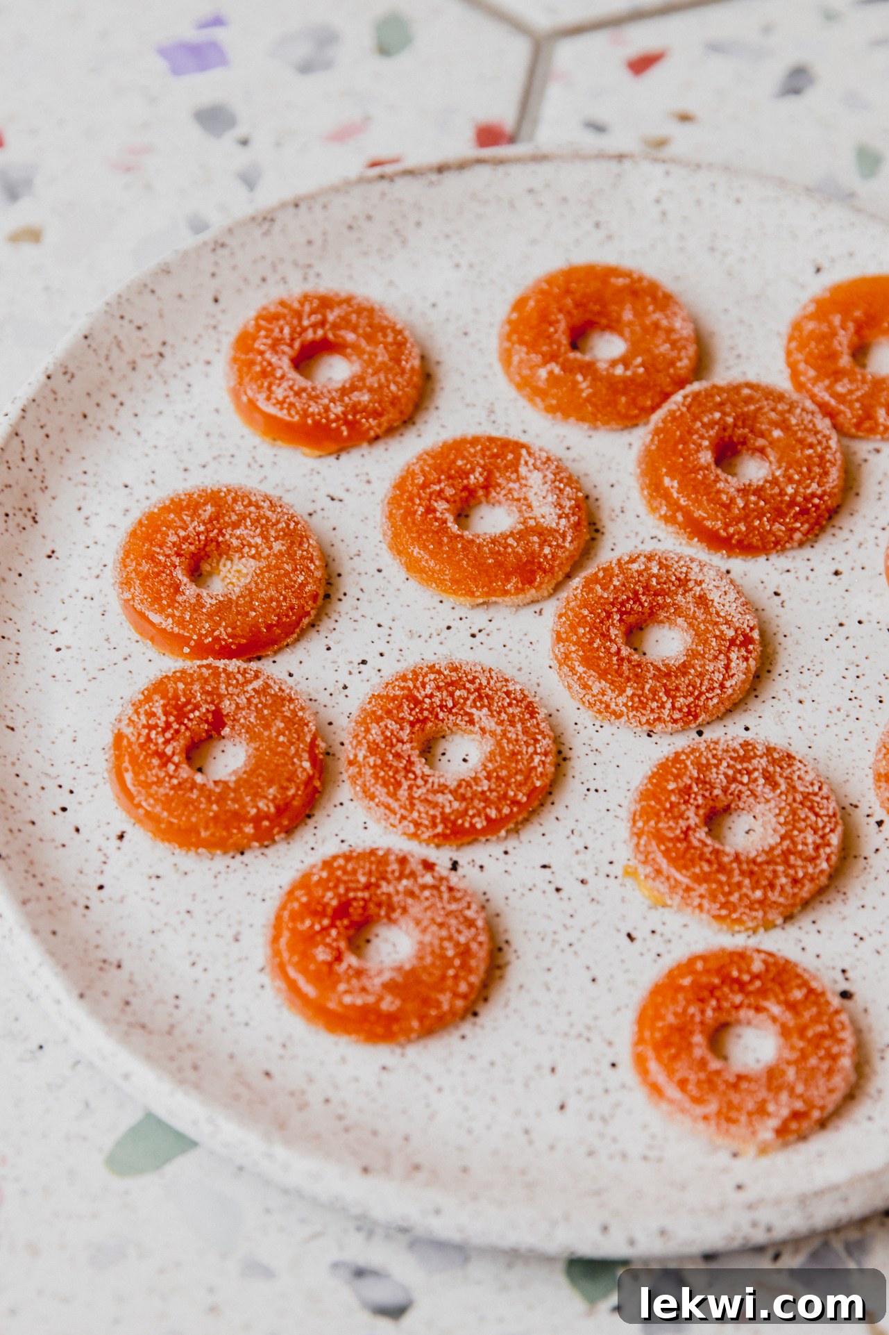 A small plate showcases a delightful arrangement of protein peach ring gummies, highlighting their perfect shape and inviting texture.