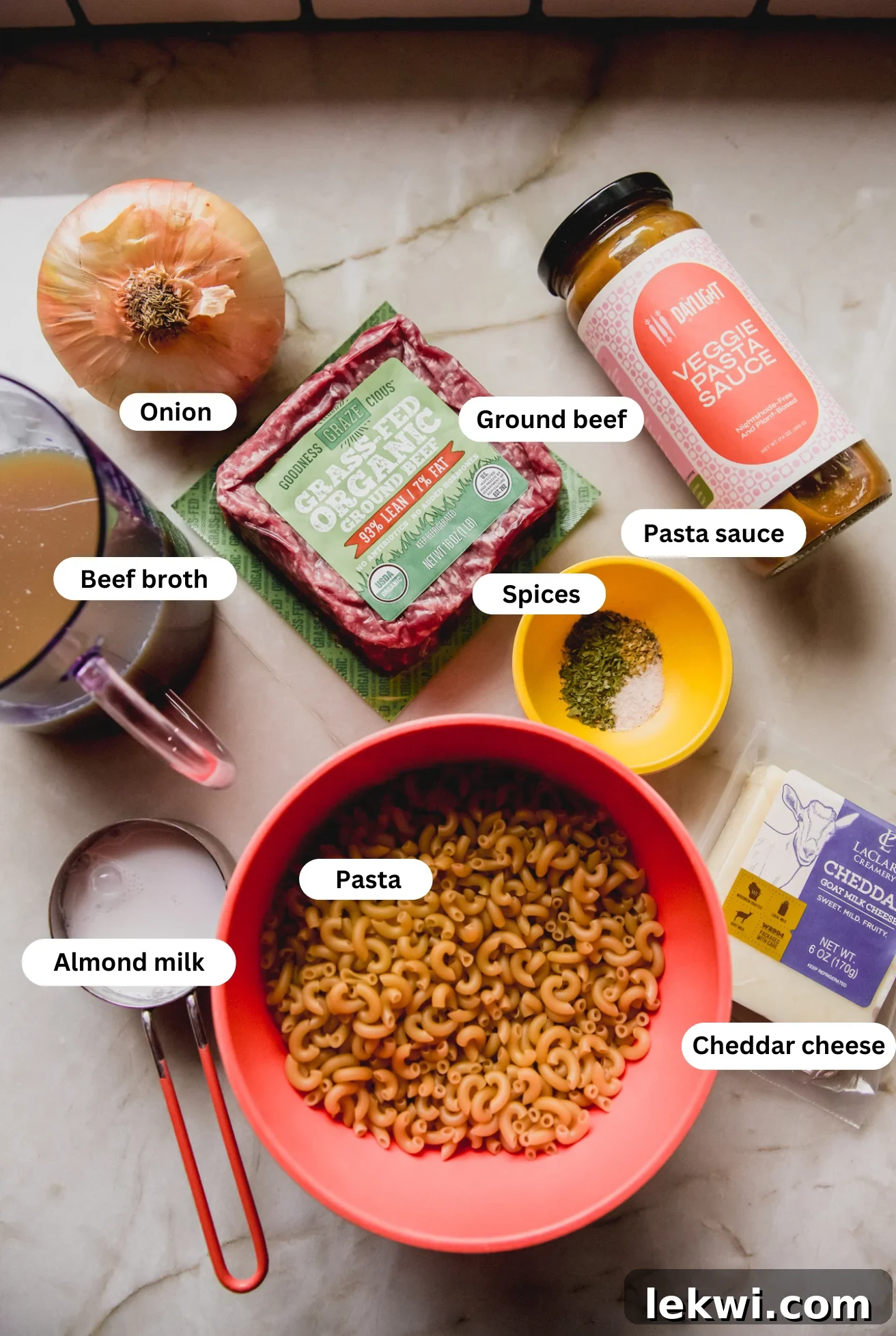 All the necessary ingredients laid out on a surface, ready to be combined for slow cooker hamburger helper.