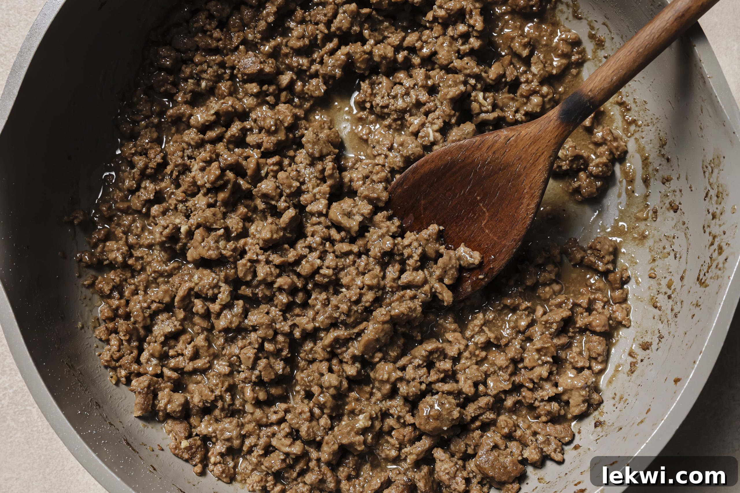 Ground beef simmering in a pan, with the gravy visibly thickening to a perfect consistency.
