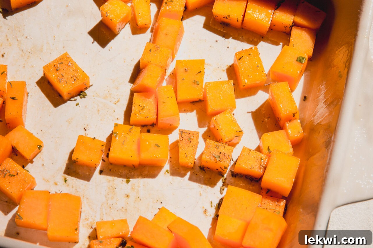The casserole dish with butternut squash in it, lightly seasoned.