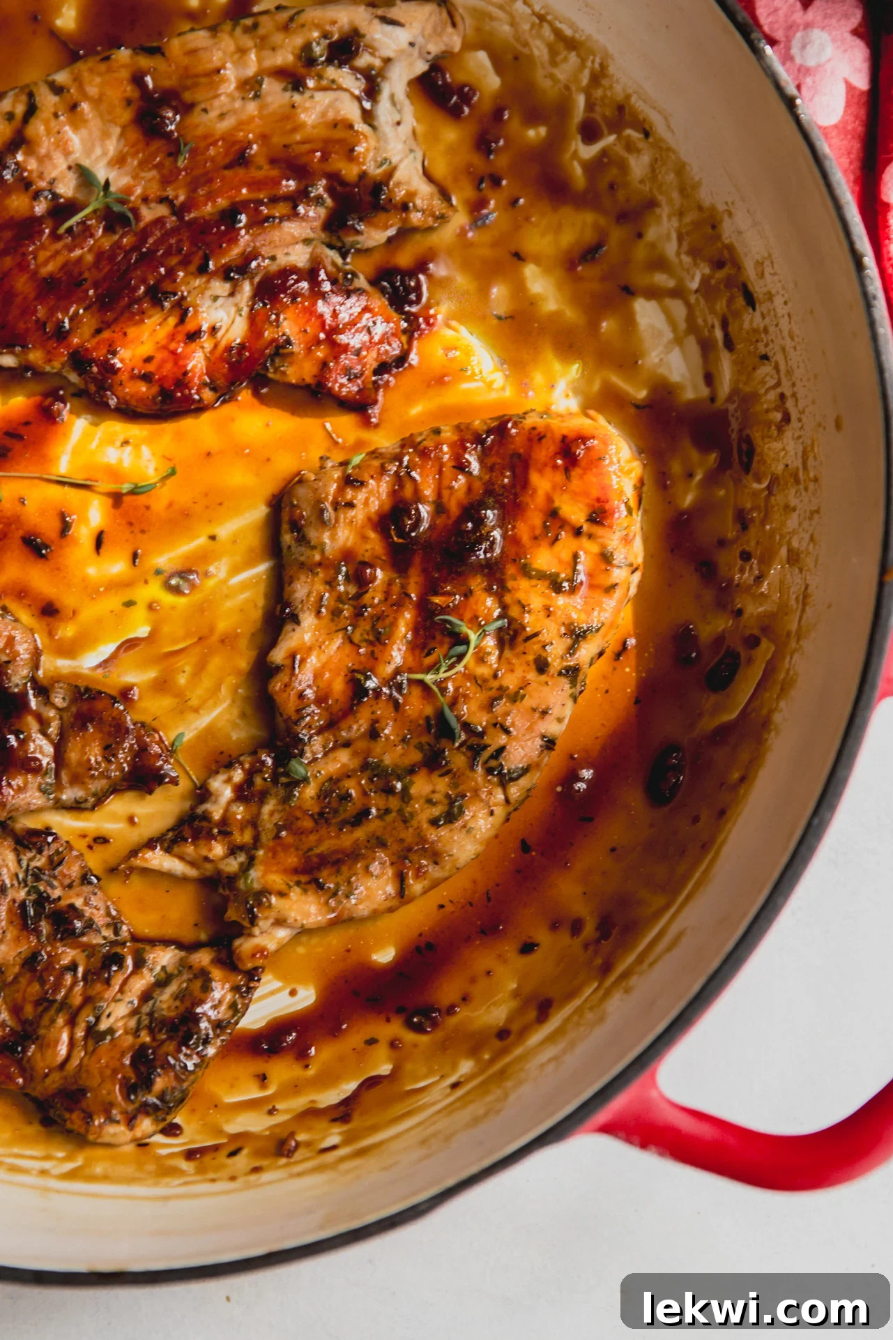 Juicy turkey cutlets with a vibrant orange glaze, beautifully plated in a large pan, ready to be served.