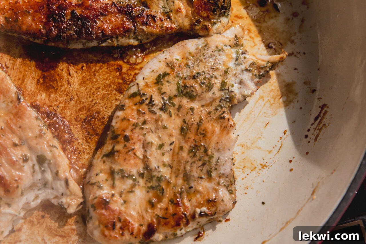 A golden-brown turkey cutlet searing in a hot pan, demonstrating proper cooking technique.