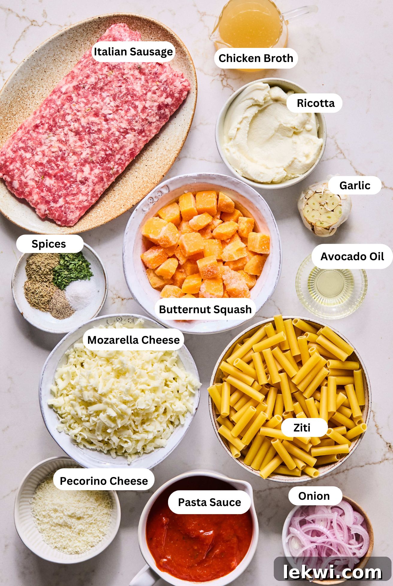 A vibrant display of all the fresh and essential ingredients laid out for preparing butternut squash baked ziti.