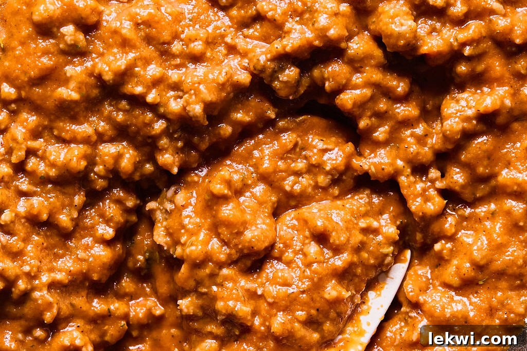 Cooked ground Italian sausage and the blended butternut squash pasta sauce combined in a large skillet.