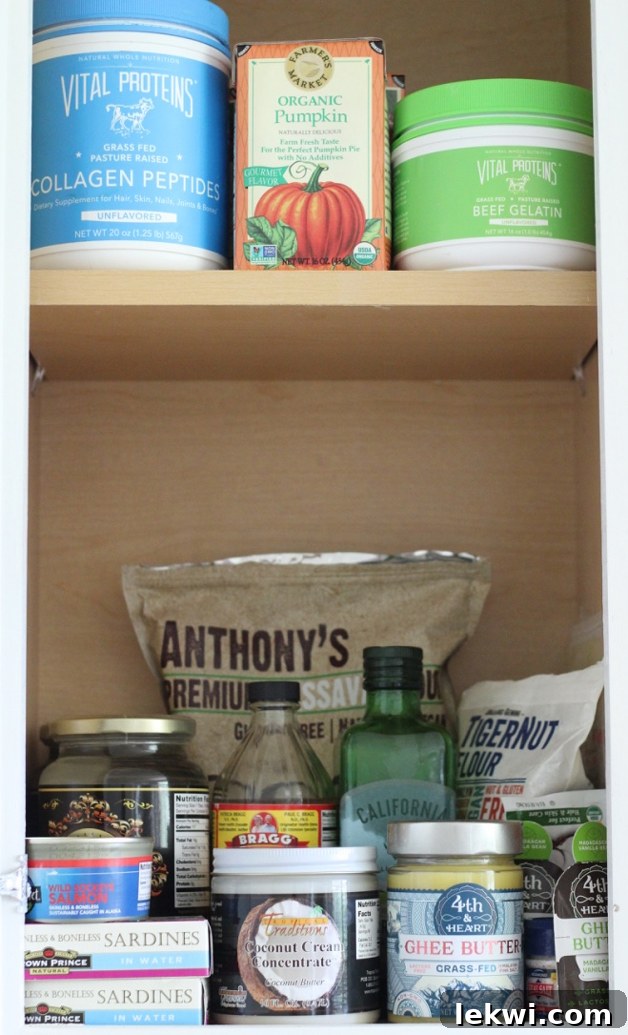 A shot of a pantry containing Cassava flour, apple cider vinegar, olive oil and many other products, highlighting essential ingredients for Paleo and AIP diets.