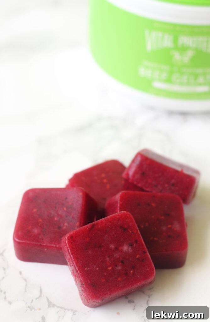 A pile of red gummies on a marble background.