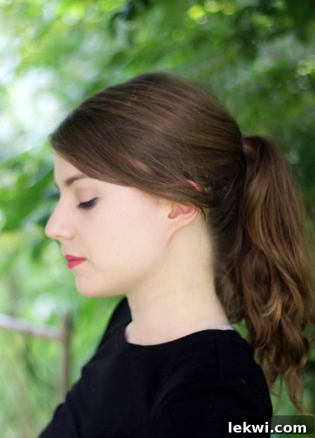 A close up of Michelle from the side while she is looking down.