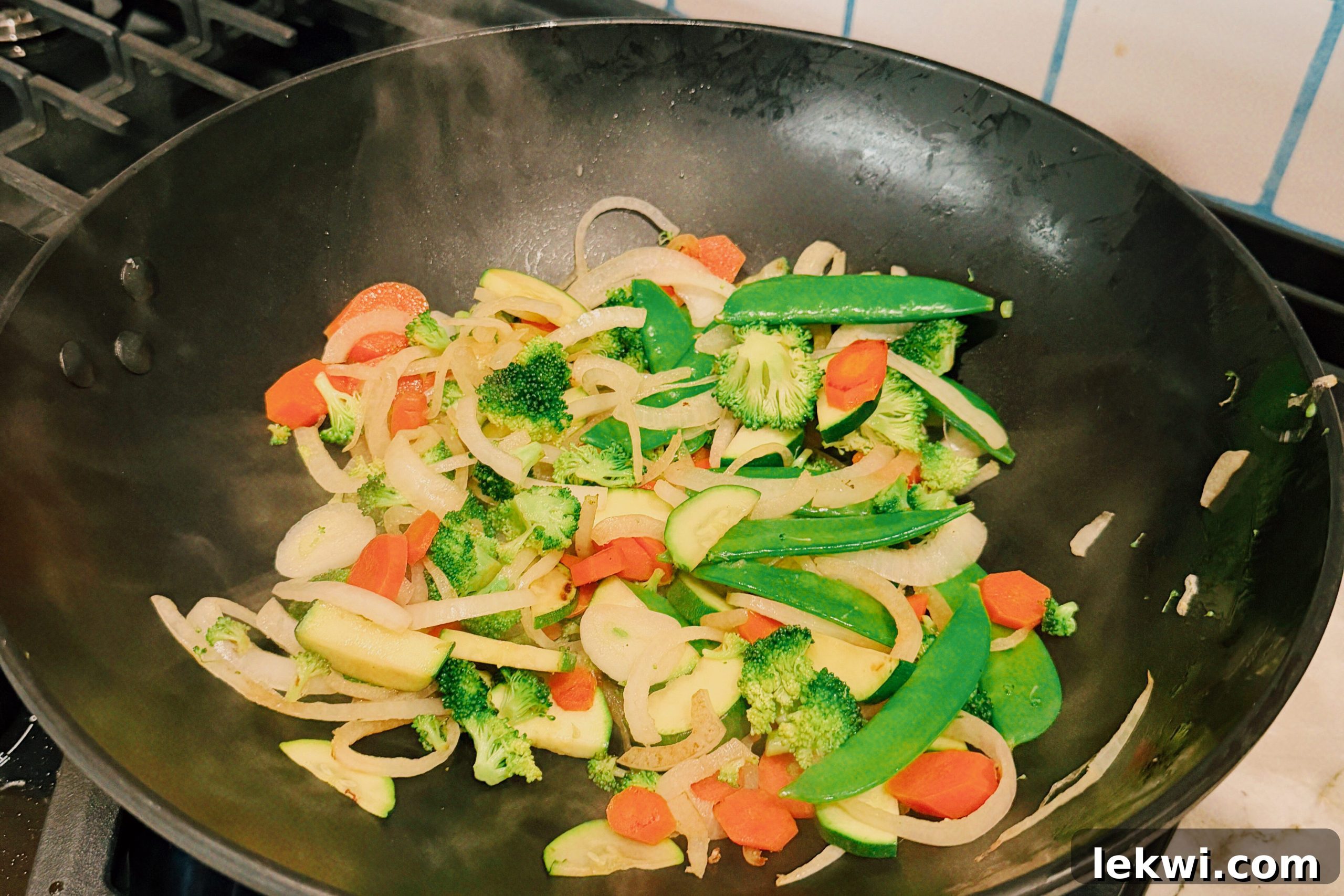 Wok-Tossed Gluten-Free Beef Noodles 6 The veggies in a wok sauting.