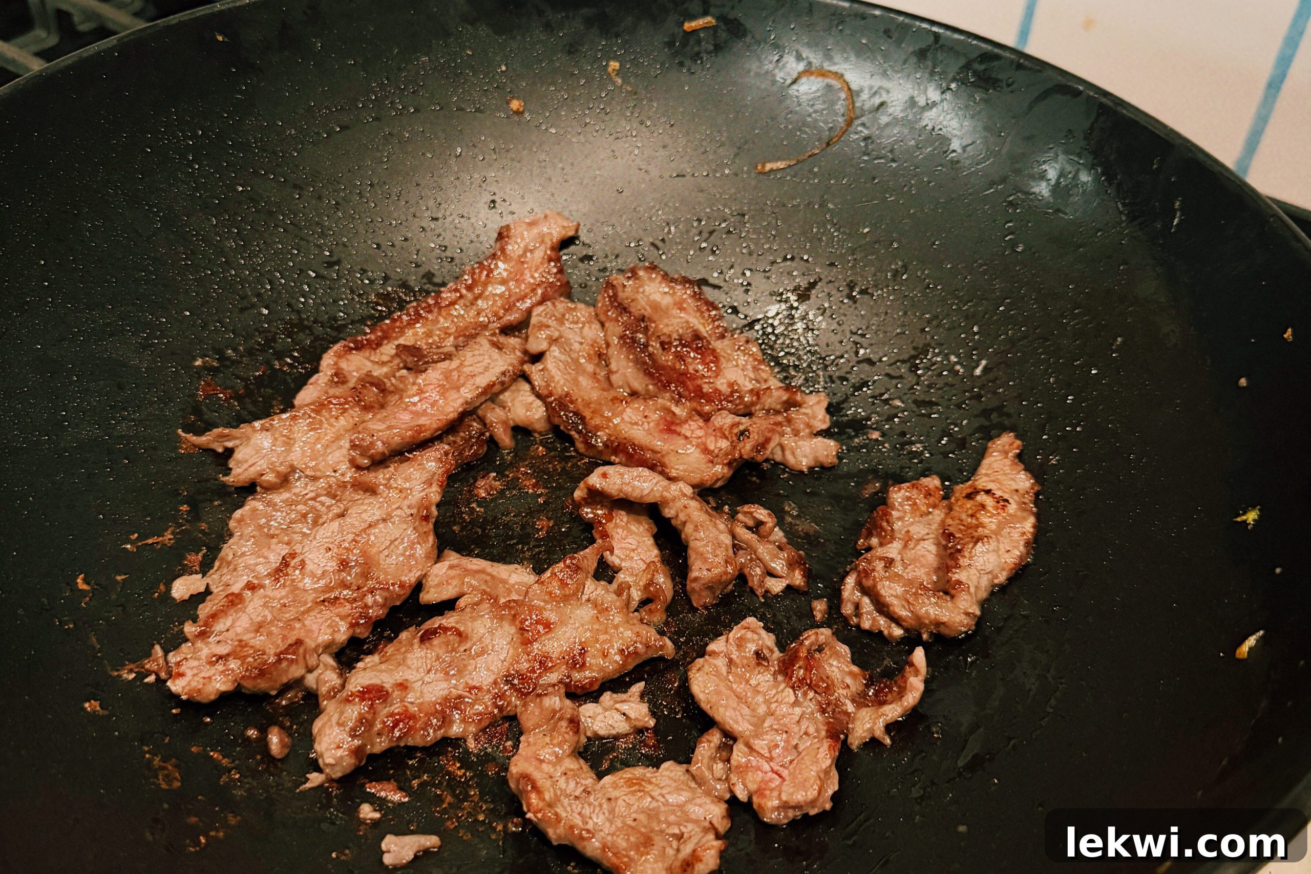 Wok-Tossed Gluten-Free Beef Noodles 7 The beef cooking in a wok.