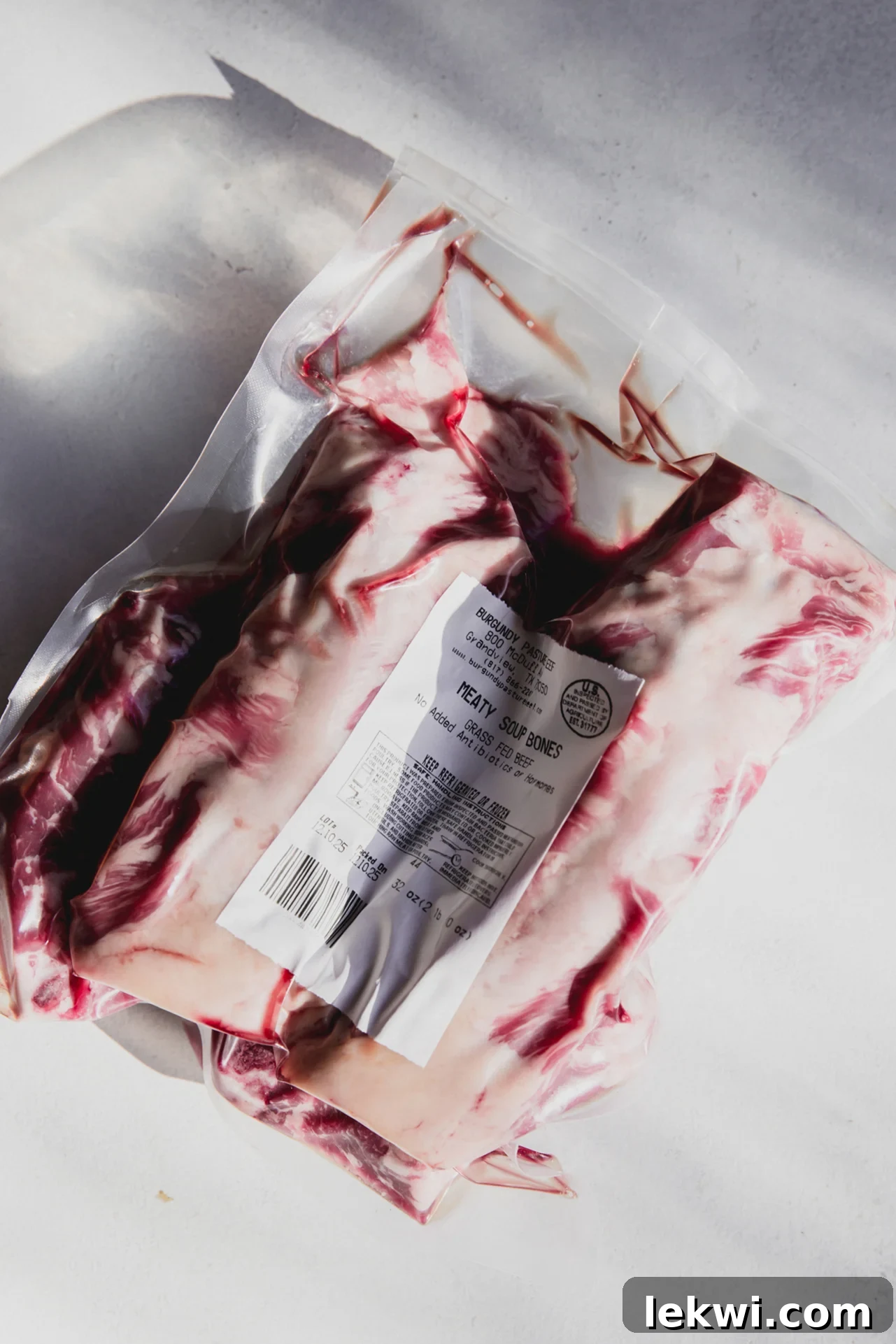 Raw beef soup bones, still in their plastic wrap, awaiting preparation for a rich bone broth.