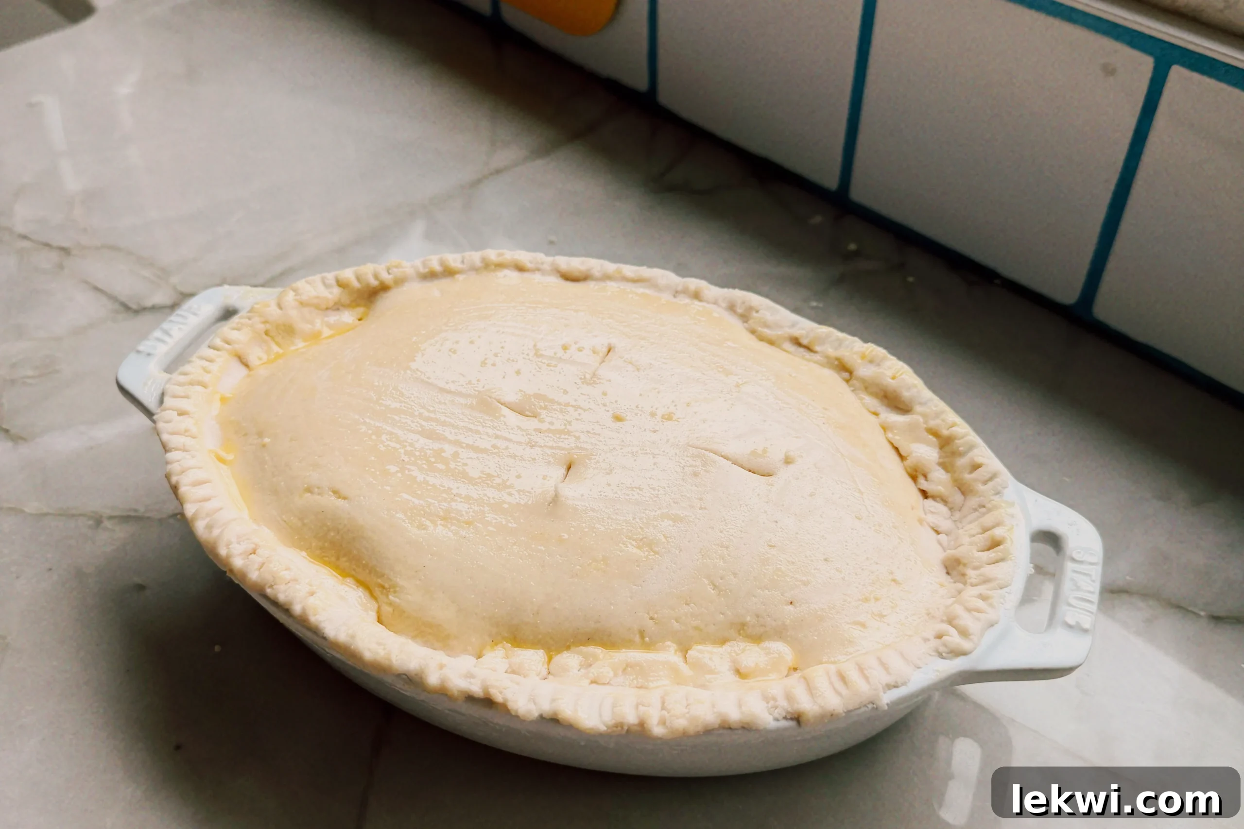 Comforting Gluten-Free Beef Pot Pie 8 Freshly baked gluten-free beef pot pie, golden brown and glistening, on a countertop, cooling.