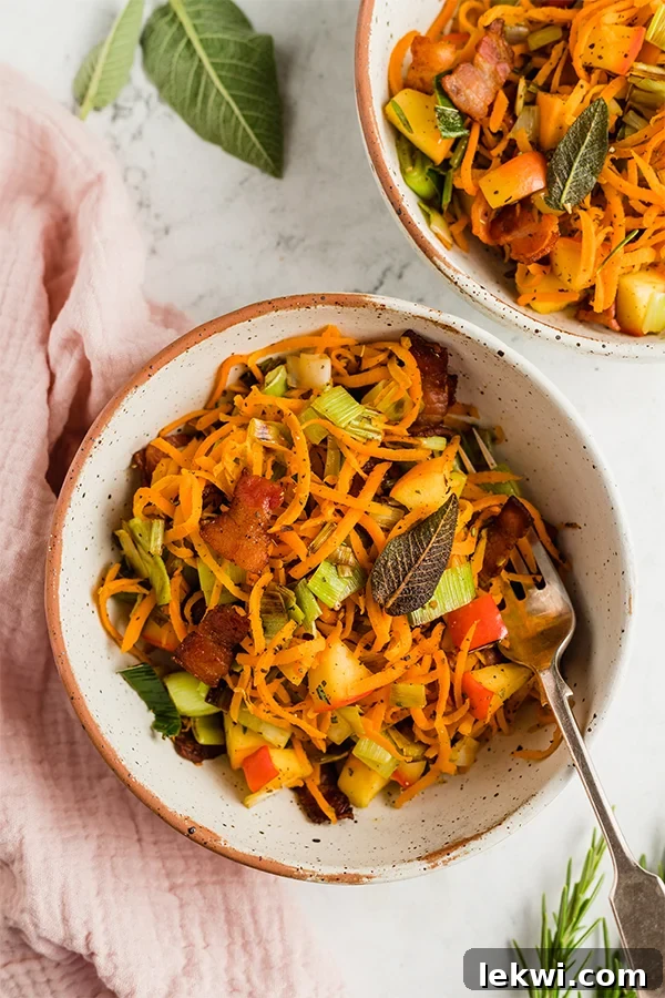 Two bowls of Carrot, Apple, & Bacon Breakfast Hash, ready to be enjoyed, with a focus on fresh presentation.