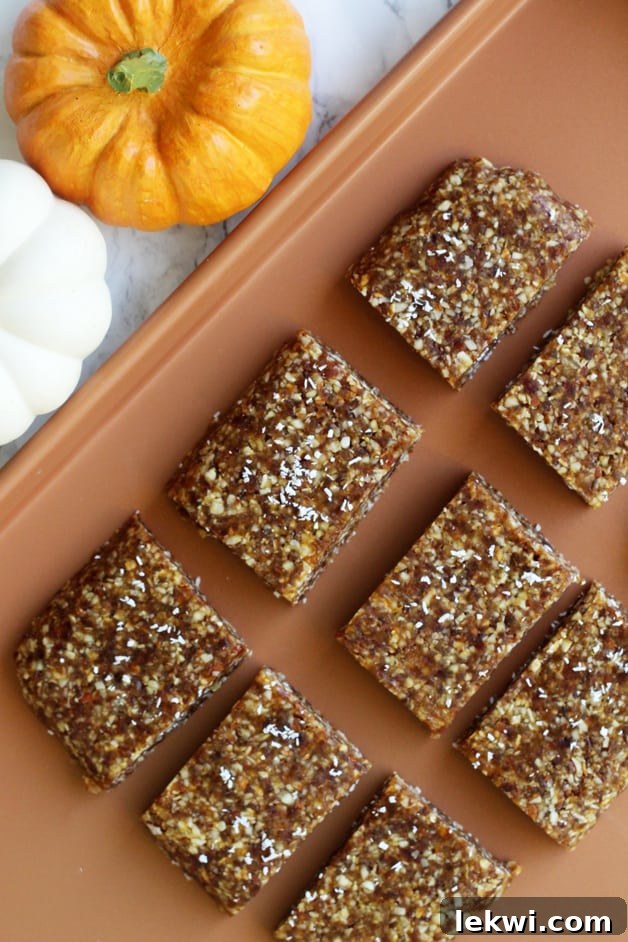 Close-up of three Pumpkin Energy Bars on a white plate with spices