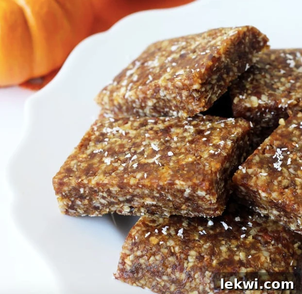 A stack of pumpkin energy bars piled on a white plate.