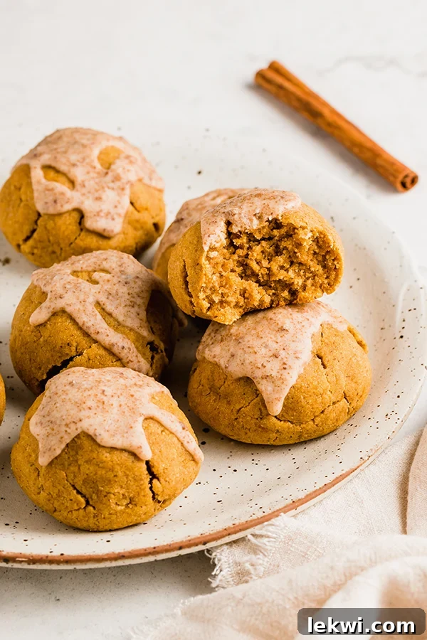 Pumpkin pie donut holes on a plate, one of which is missing a bite.