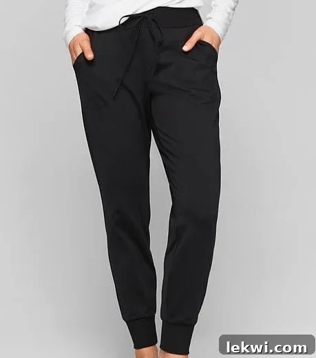 A person wearing a pair of black joggers.