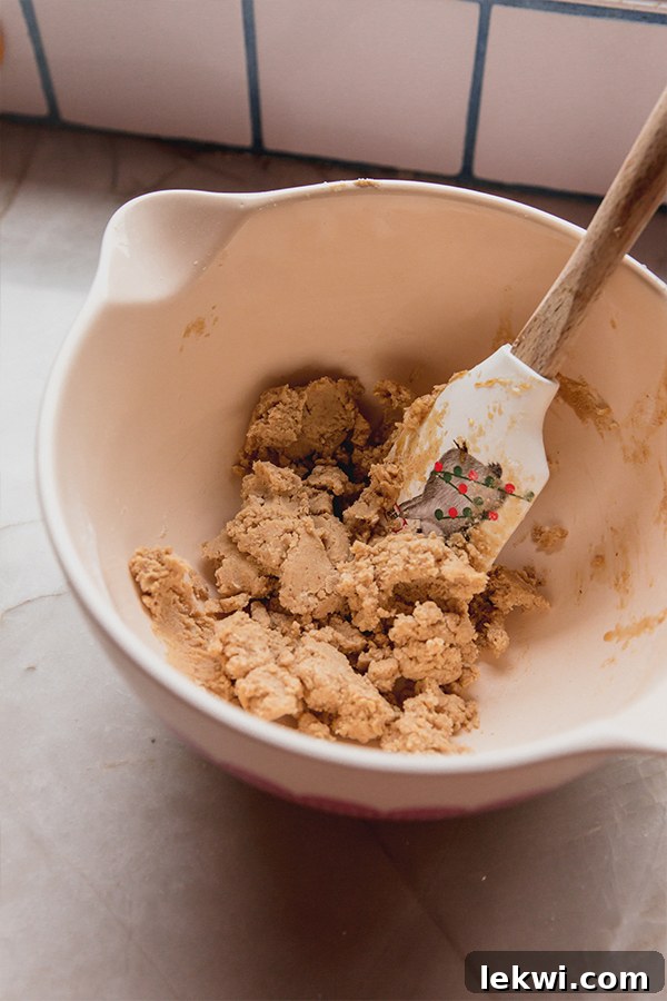 A bowl of gingerbread donut holes dough being mixed.