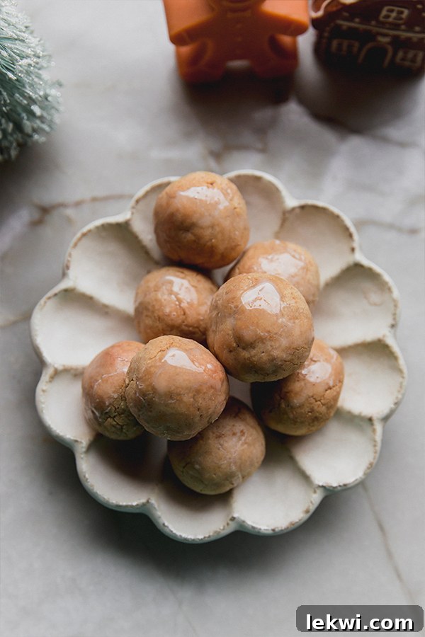 A serving plate filled with gingerbread donut holes.