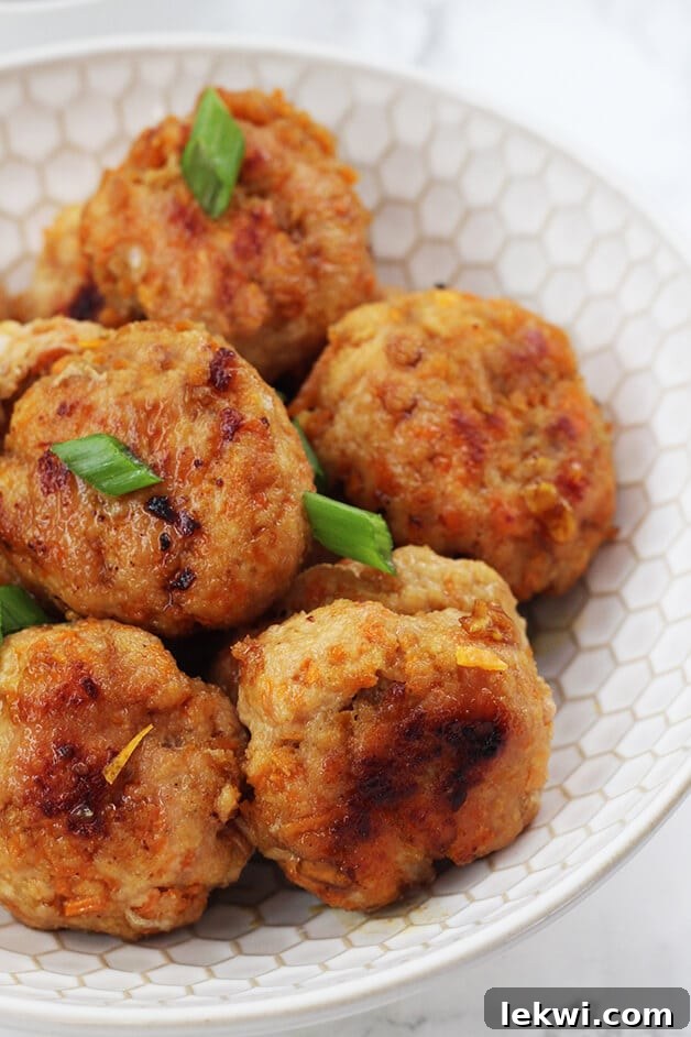 A final close-up of Paleo Whole30 AIP Orange Chicken Poppers in a white bowl, ready to be served.
