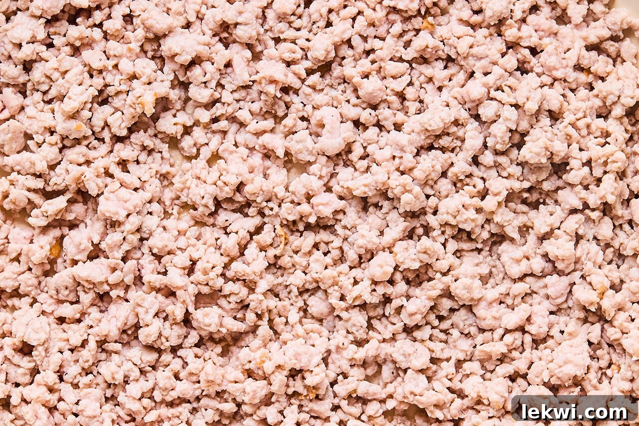 A skillet with ground pork browning in it.